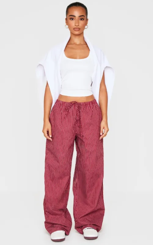 Petite Burgundy Pinstripe Woven Drawstring Waist Low Rise Trousers sold by Pretty Little Thing