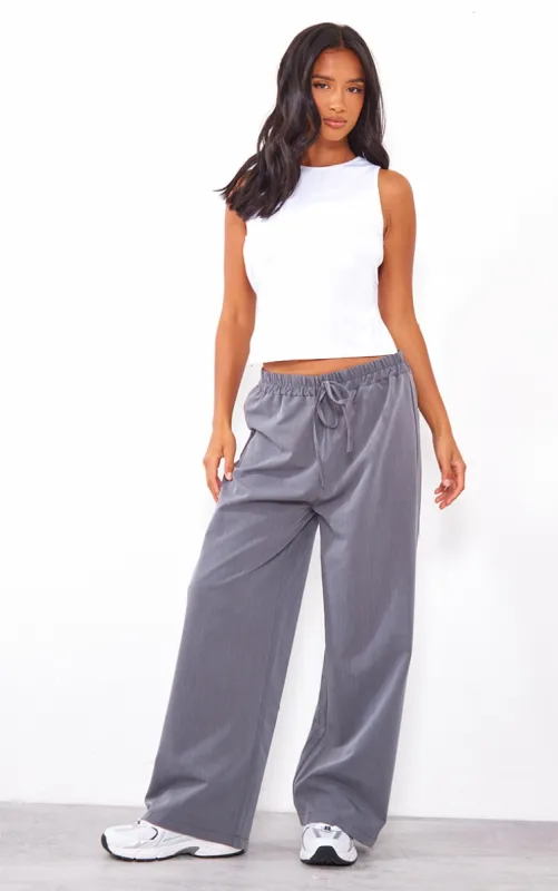 Petite Charcoal Woven Tie Waist Trousers sold by Pretty Little Thing