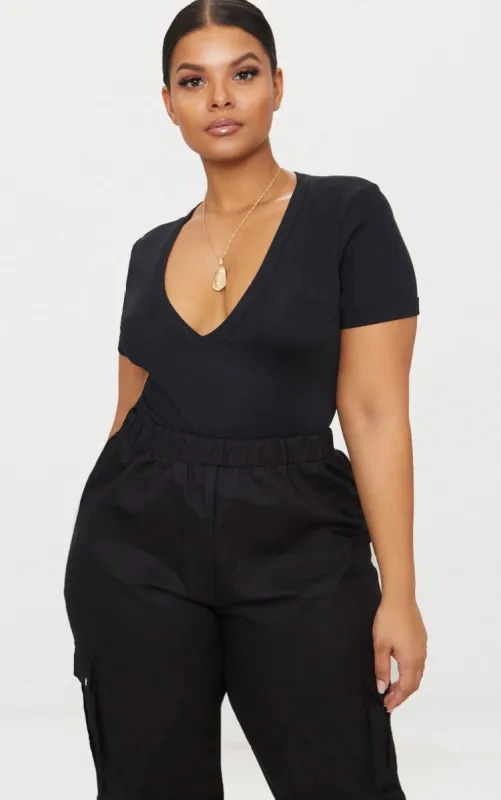 Plus Black Ribbed Plunge Short Sleeve Bodysuit sold by Pretty Little Thing
