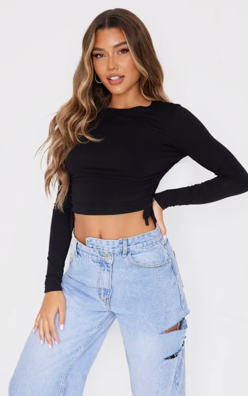 Black Jersey Ruched Side Long Sleeve Crop Top sold by Pretty Little Thing