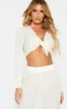Cream Textured Tie Front Long Sleeve Crop Top sold by Pretty Little Thing