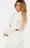 Cream Textured Tie Front Long Sleeve Crop Top sold by Pretty Little Thing