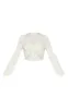 Cream Textured Tie Front Long Sleeve Crop Top sold by Pretty Little Thing