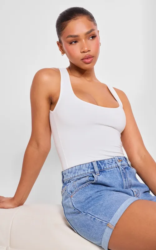 Basic White Cotton Blend Racer Back Bodysuit sold by Pretty Little Thing