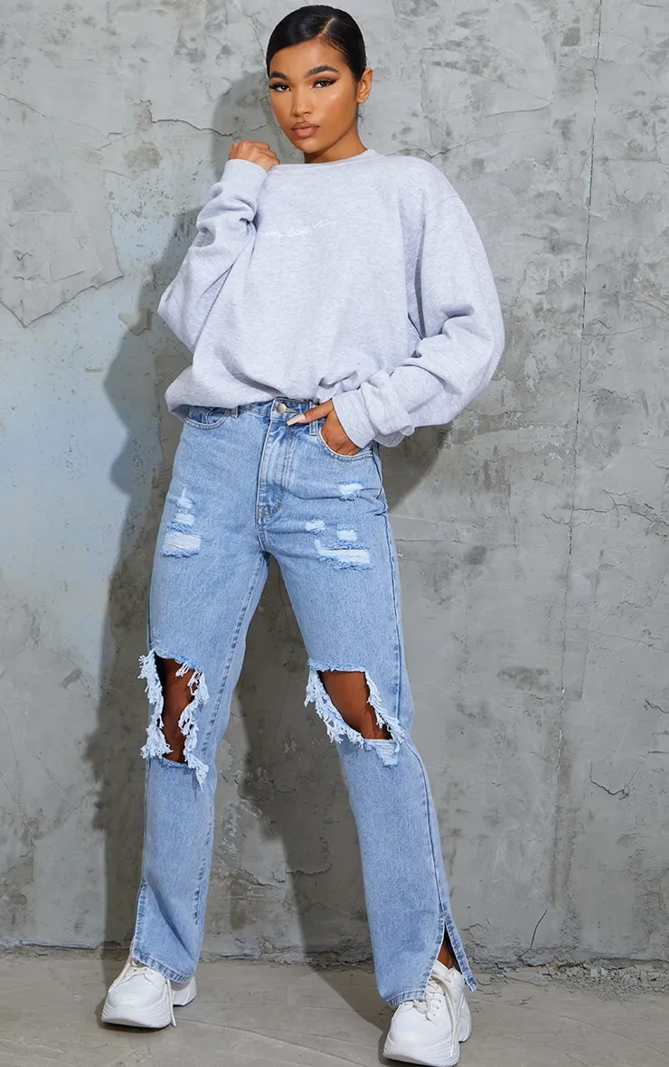 Light Blue Wash Ripped Open Knee Split Hem Jeans sold by Pretty Little Thing