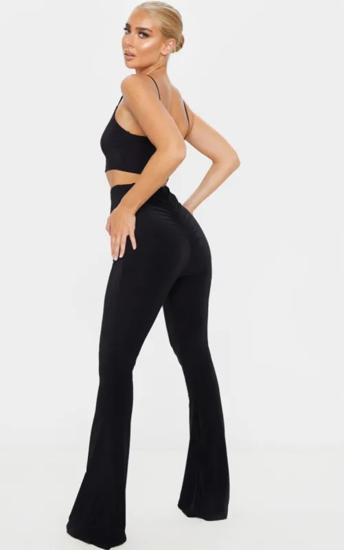 Black Flare Ruched Bum Slinky Trousers sold by Pretty Little Thing