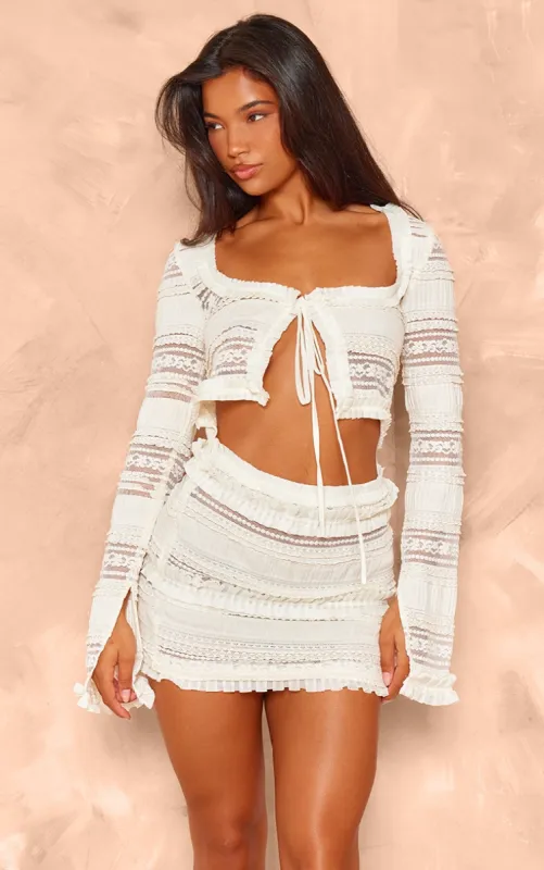 Cream Textured Ruffle Cut Out Tie Bodycon Dress sold by Pretty Little Thing