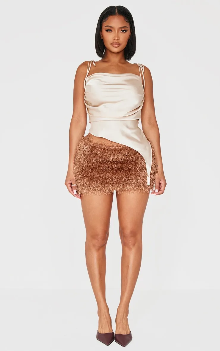 Shape Chocolate Low Rise Faux Leather Tassle Mini Skirt sold by Pretty Little Thing