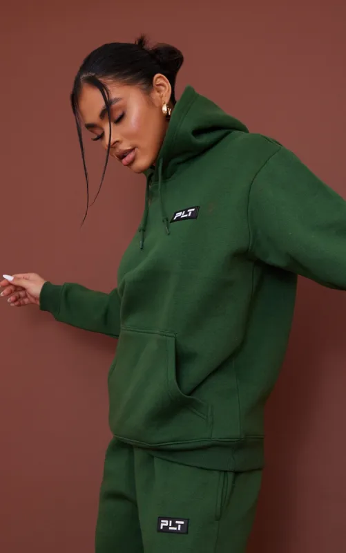 PRETTYLITTLETHING Forest Green Logo Badge Detail Oversized Hoodie sold by Pretty Little Thing