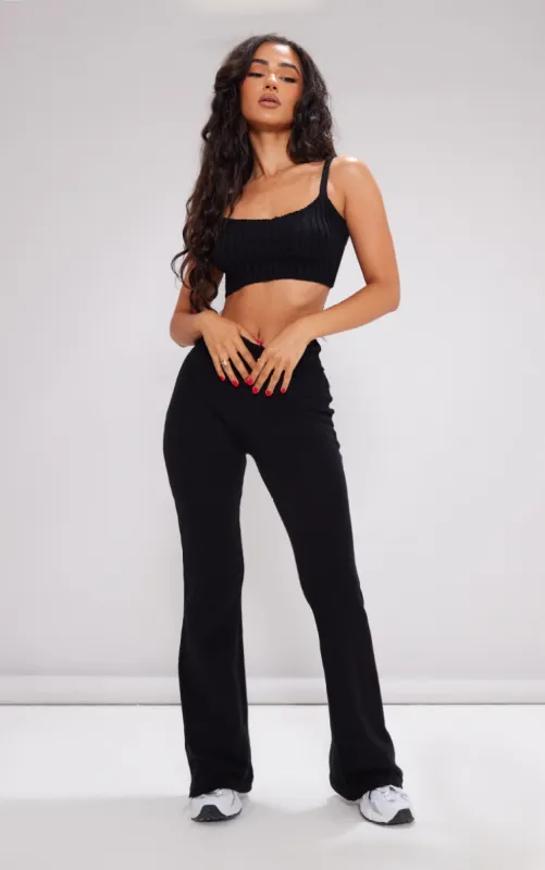Petite Black Knitted Fold Over Waist Flared Trousers sold by Pretty Little Thing