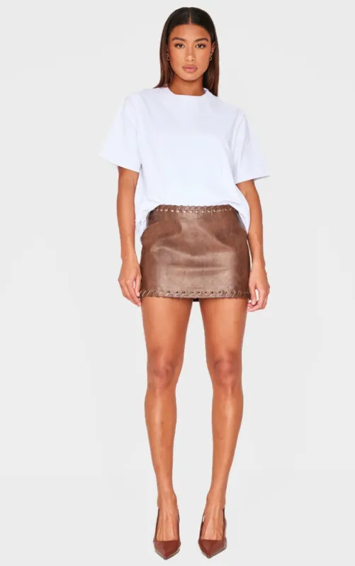 Chocolate Brown Faux Leather Plaited Mini Skirt sold by Pretty Little Thing