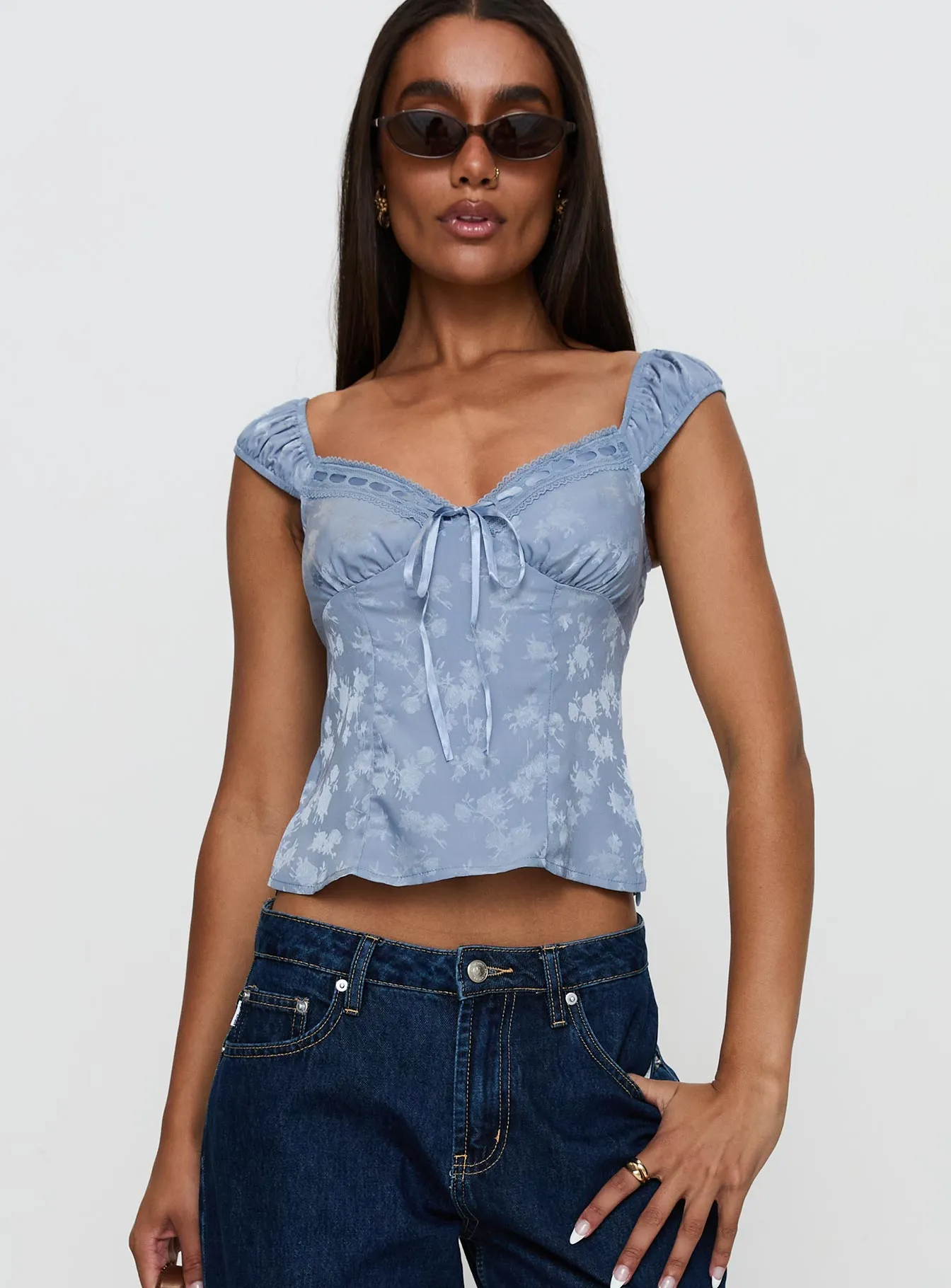 Branwen Cap Sleeve Tie Detail Top Blue Floral sold by Princess Polly