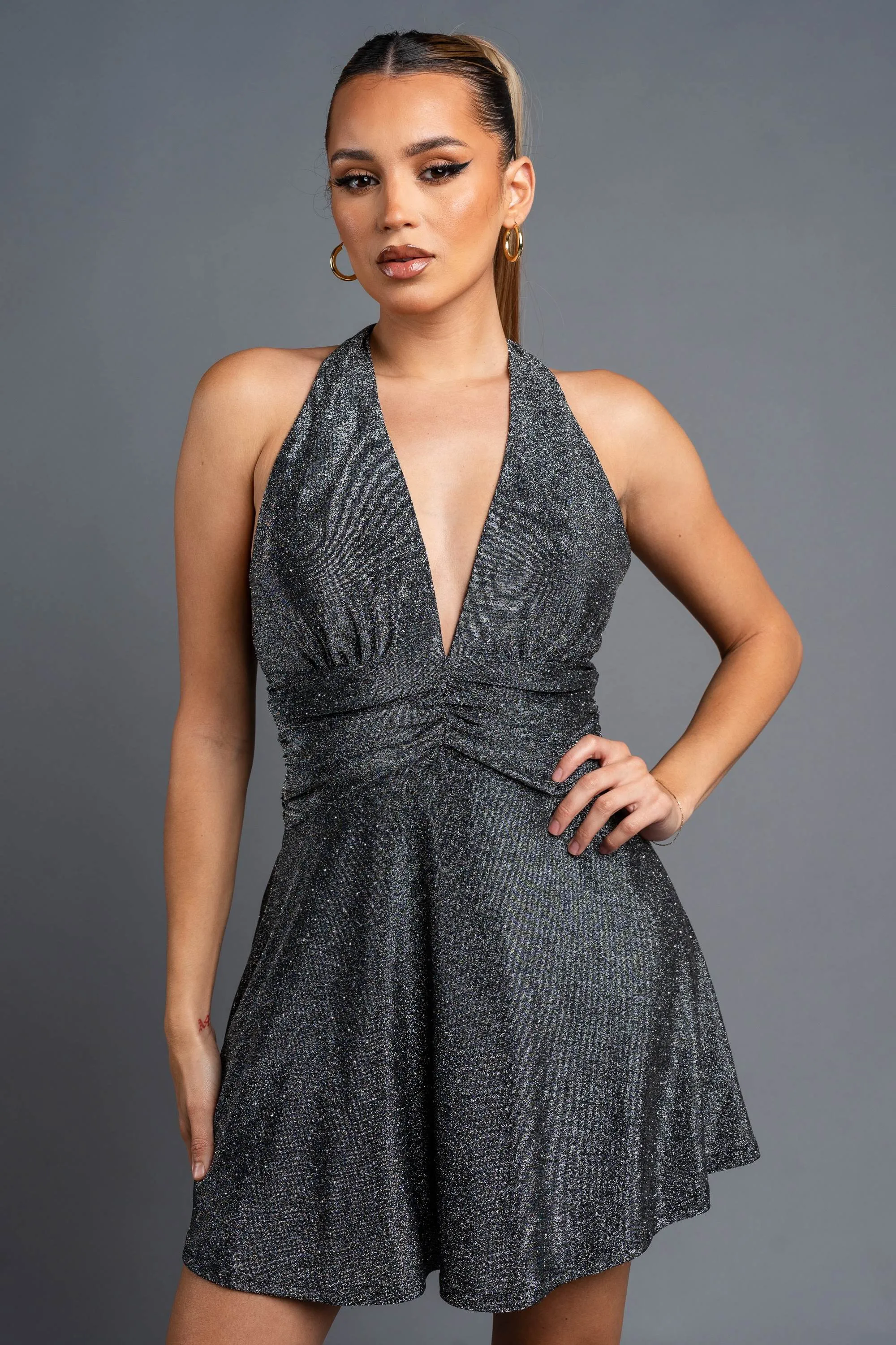 METALLIC SLINKY STUDDED HALTER SKATER MINI DRESS sold by privy