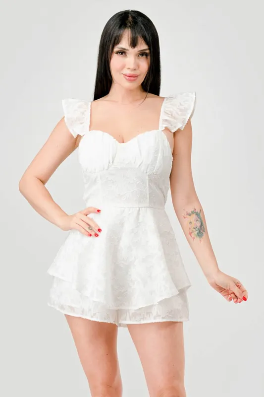 PJ11052E-W / LUXE TEXTURED SMOCKED RUFFLED FLUTTER ROMPER sold by privy