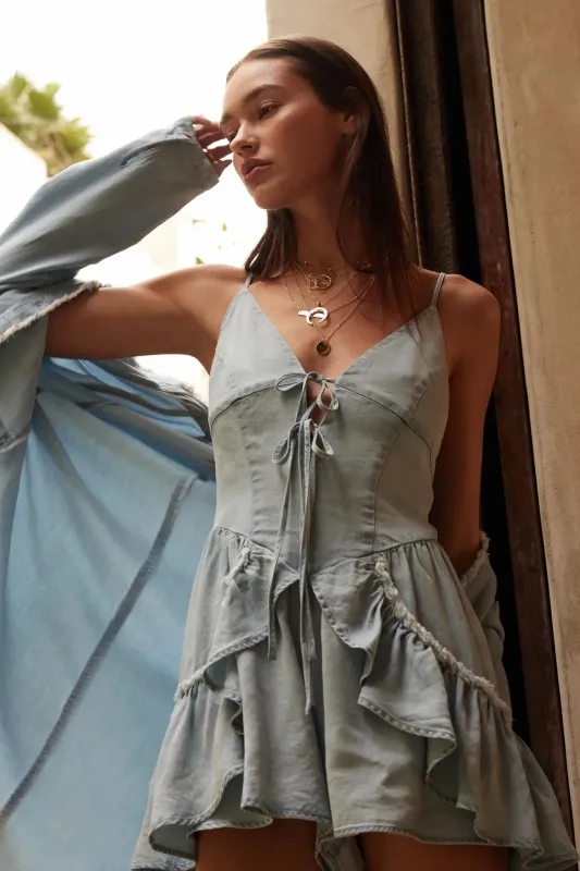 Above the Clouds Ruffled Denim Tie-Front Romper sold by Promesa