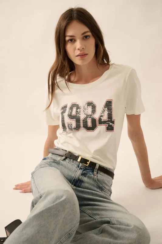 1984 Vintage-Print Varsity Graphic Tee sold by Promesa