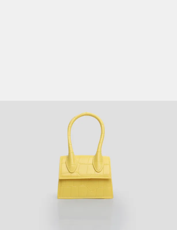 The Alora Yellow Rubber Effect Mini Bag sold by Public Desire