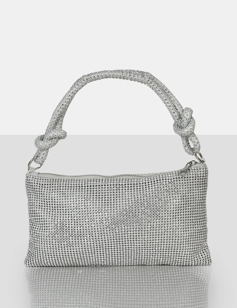 The Ingrid Silver Diamante Zip Up Knot Detail Mini Shoulder Bag sold by Public Desire