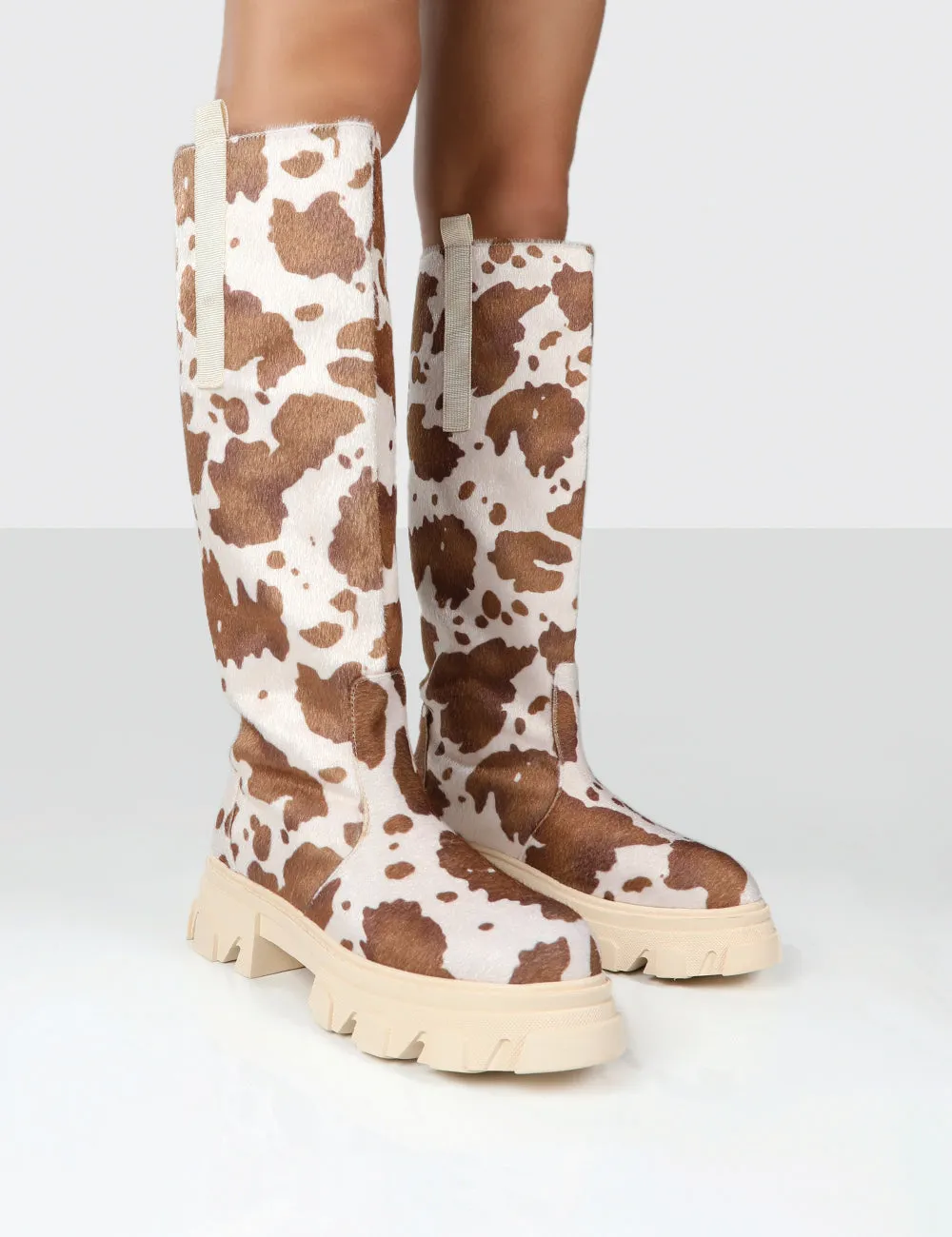 Amber x Public Desire Genius Cow Print Knee High Chunky Sole Boot sold by Public Desire