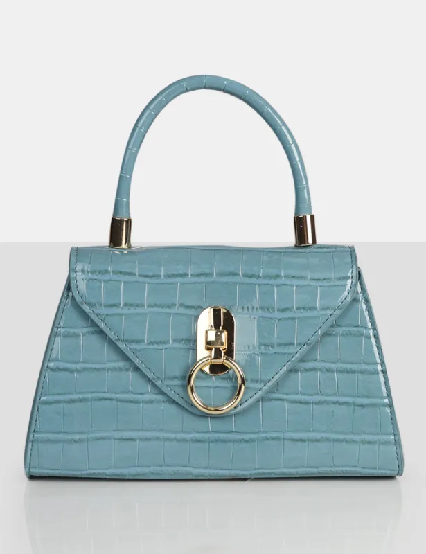The Nia Blue Croc Pu Mini Handbag sold by Public Desire