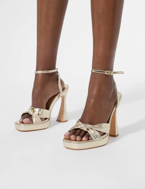Trendsetter Cracked Gold Pu Knot Detail Flare Platform Heels sold by Public Desire