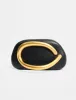 The Fern Black Gold Detail Hard Clutch Bag sold by Public Desire