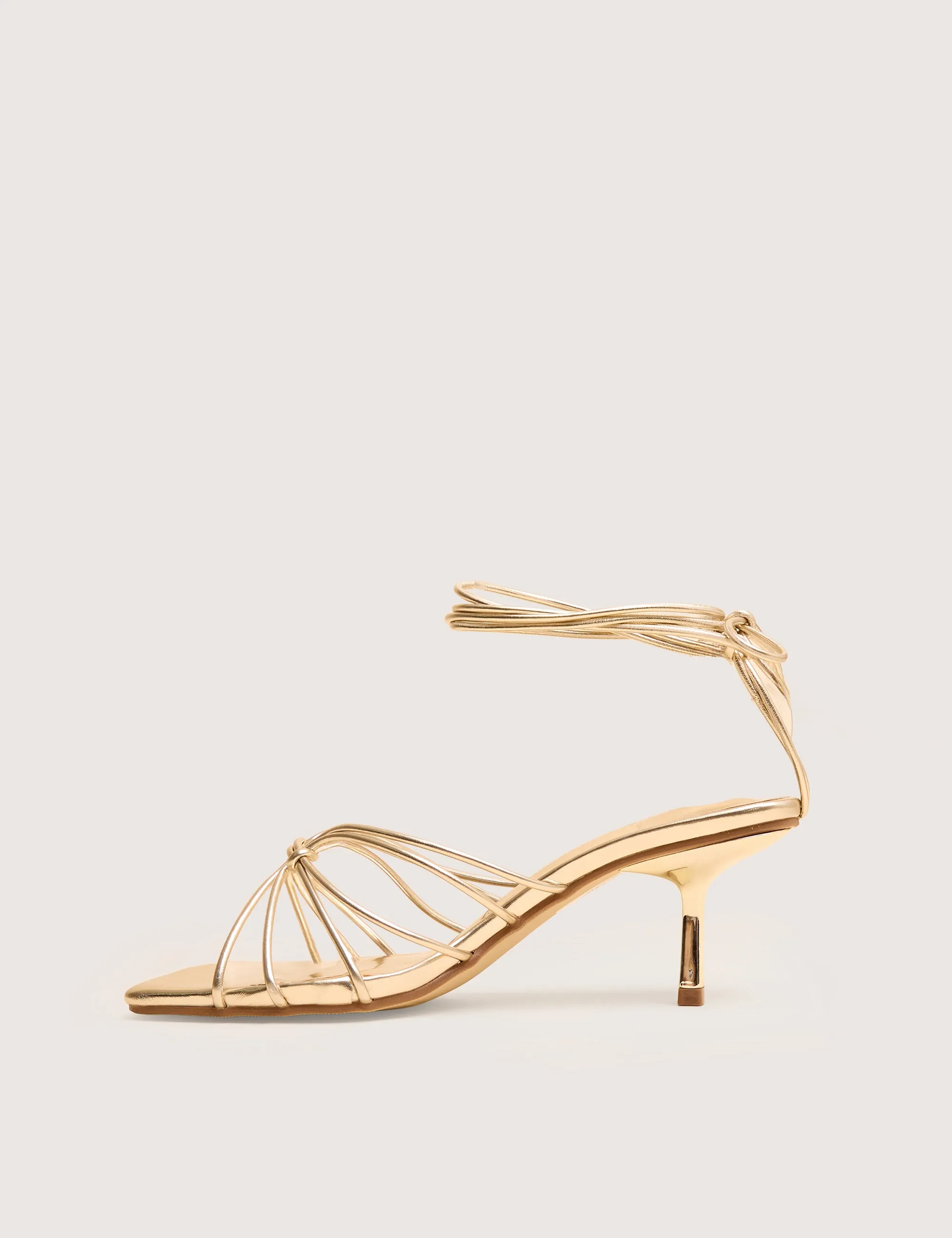 Nora Wide Fit Gold Pu Lace Up Strappy Mid Heels sold by Public Desire