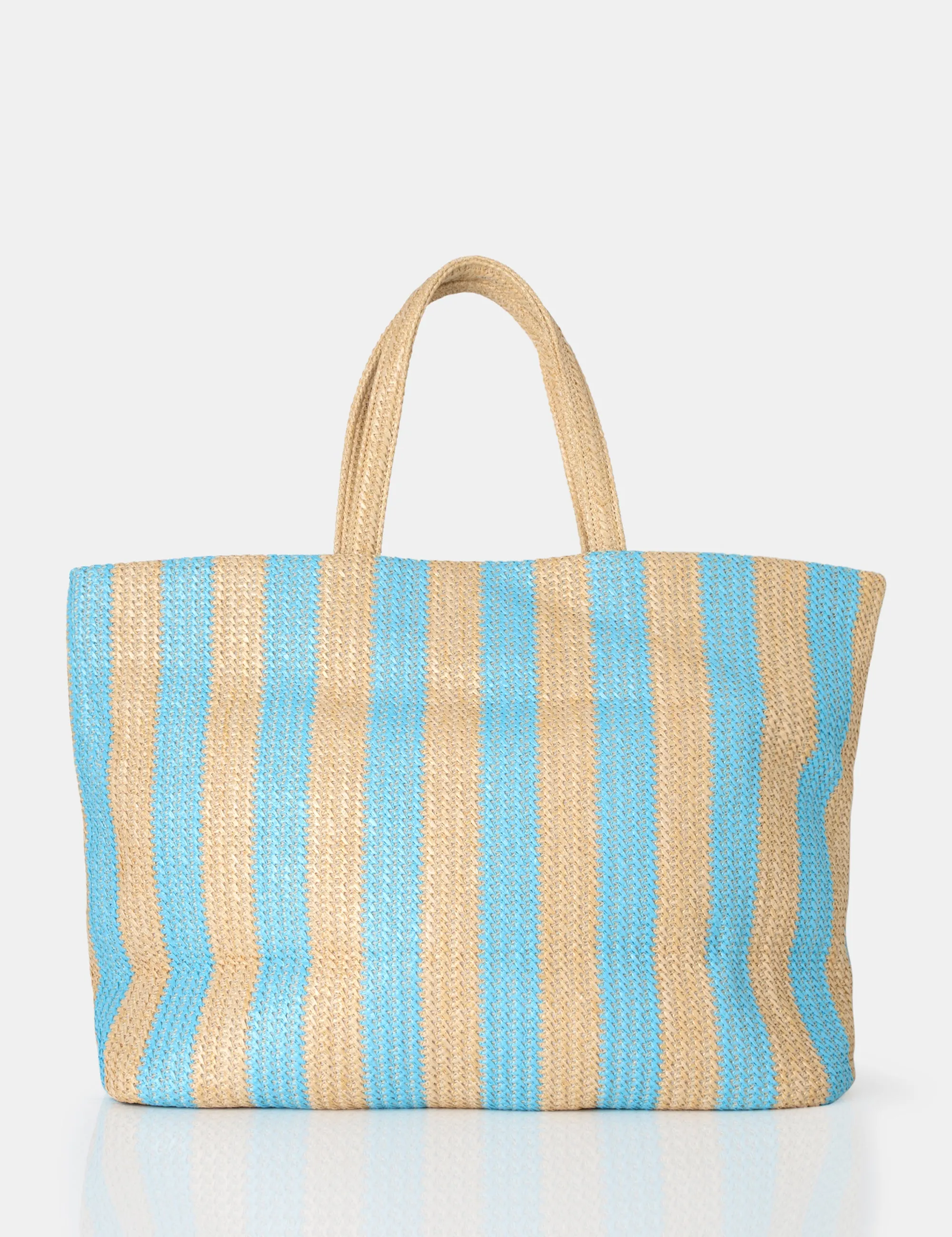 The Nikki Blue Stripe Canvas Top Handle Tote Bag sold by Public Desire
