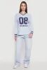 Almost Famous Varsity Graphic Long Sleeve Top sold by Rainbow