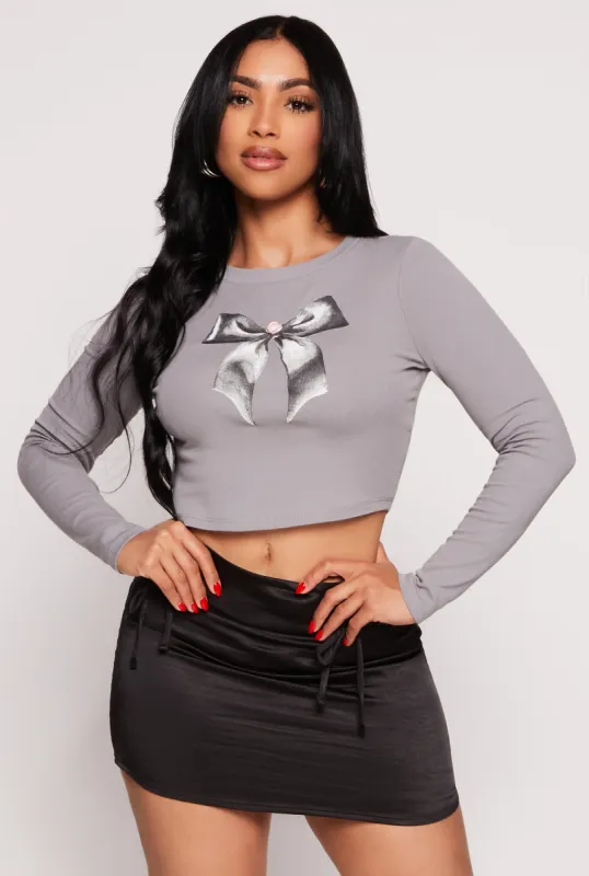 Almost Famous Bow Graphic Long Sleeve Crop Top sold by Rainbow