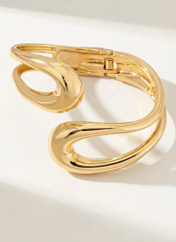 Sculptural open-form gold bangle made by Rebdolls
