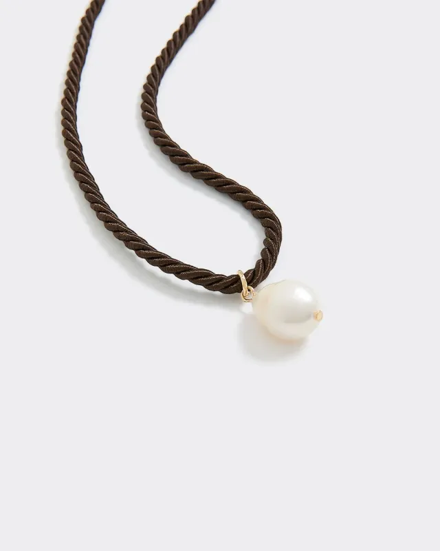 Short Cord Necklace with Pearl sold by Reitmans