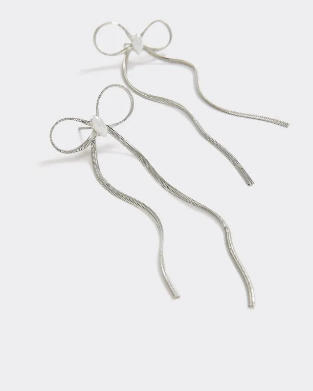 Delicate Bow Earrings with Pearls sold by Reitmans