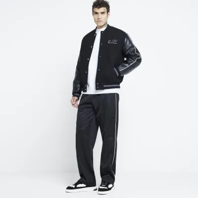 Black Regular Fit Piped Joggers sold by River Island