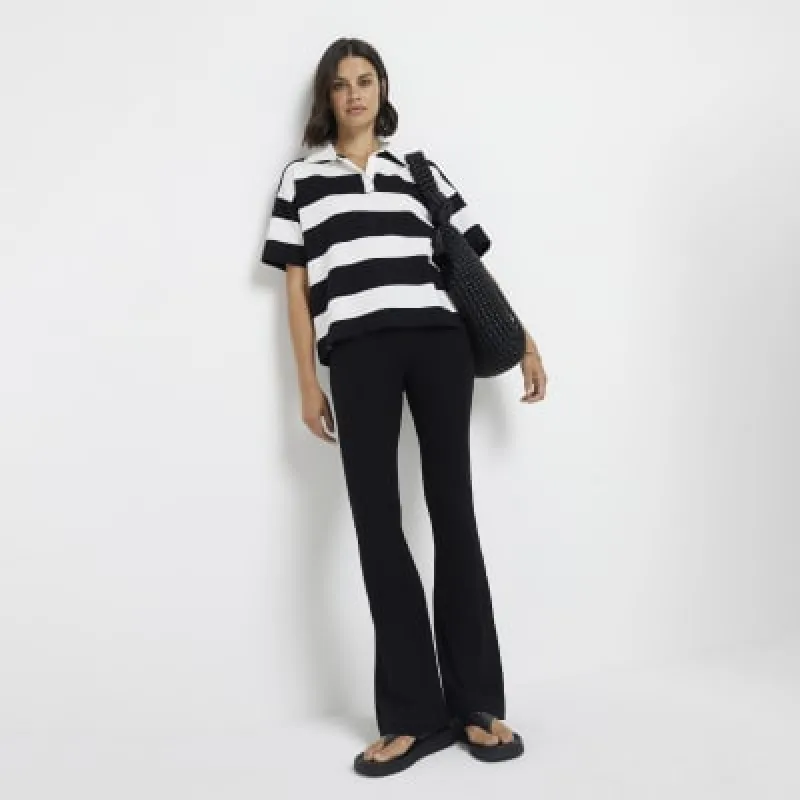 Black high waisted flared leggings sold by River Island