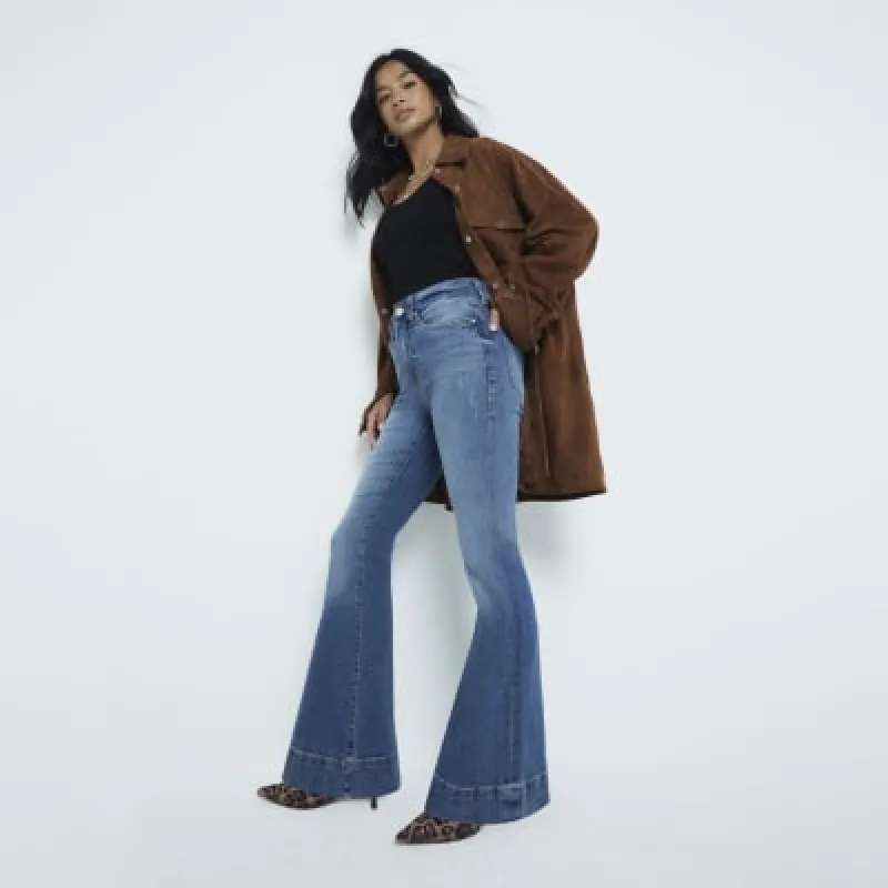 Petite Blue tummy hold flared jeans sold by River Island