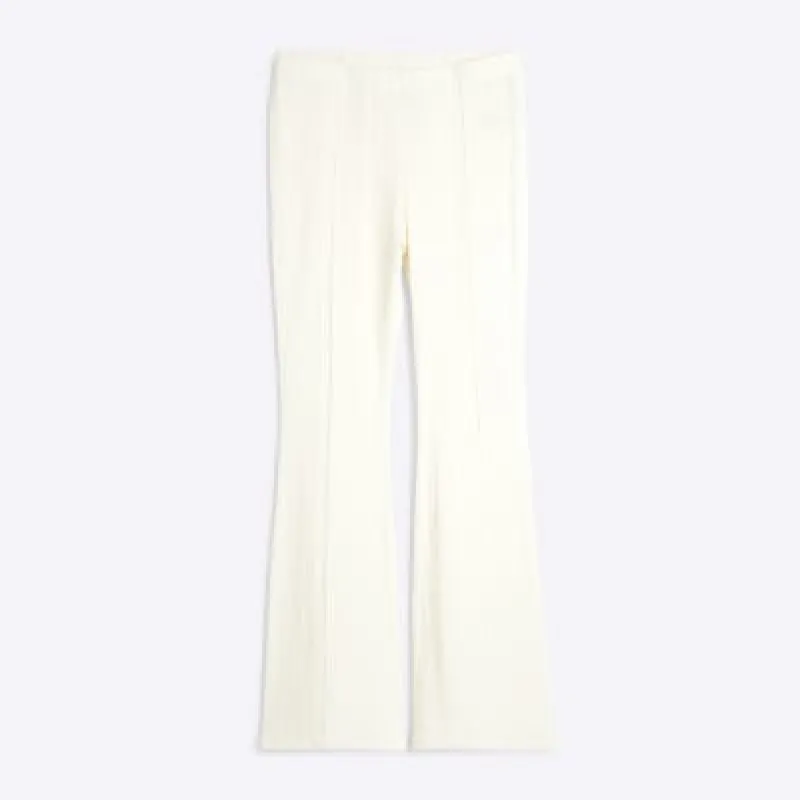 Petite Cream Textured Flared Trousers sold by River Island