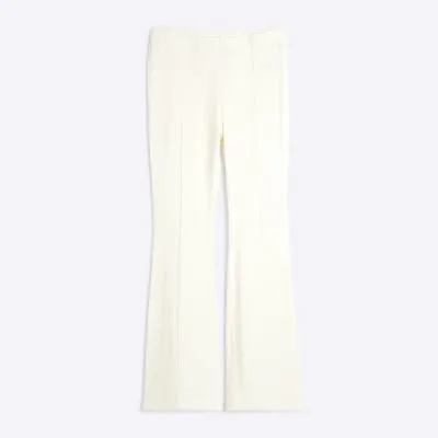 Petite Cream Textured Flared Trousers sold by River Island