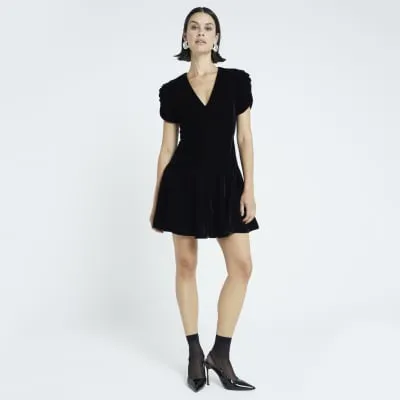 Black velvet v-neck mini dress sold by River Island