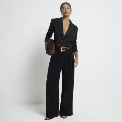 Petite black pleated wide leg trousers sold by River Island