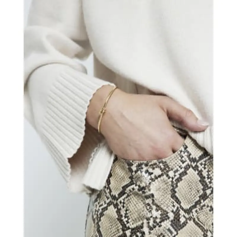 Gold Stainless Steel Knot Bangle Bracelet sold by River Island