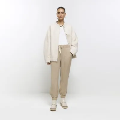 Beige lyocell cuffed joggers sold by River Island