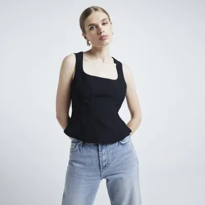 Black tailored peplum top sold by River Island