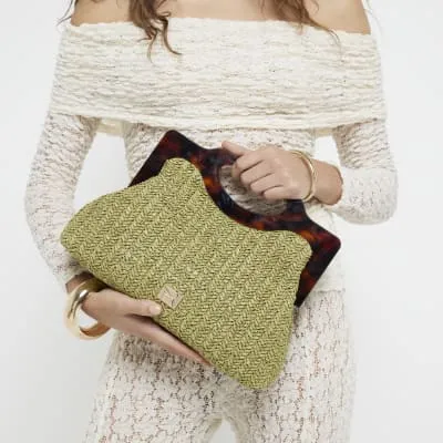 Green raffia clutch bag sold by River Island