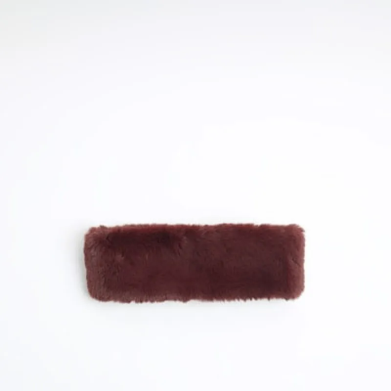 Red faux fur headband sold by River Island