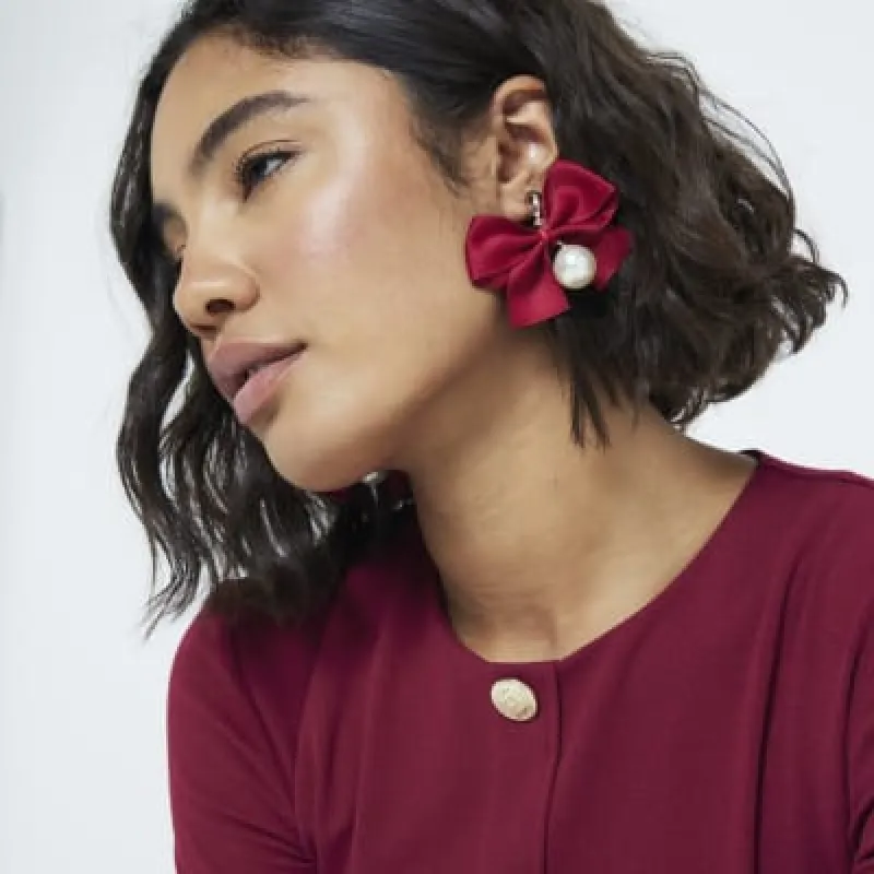 Red Christmas Ribbon Bow Pearl Drop Earrings sold by River Island