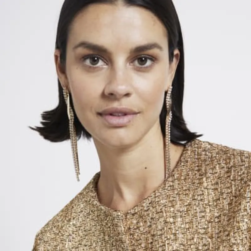 Gold snake diamante drop earrings sold by River Island