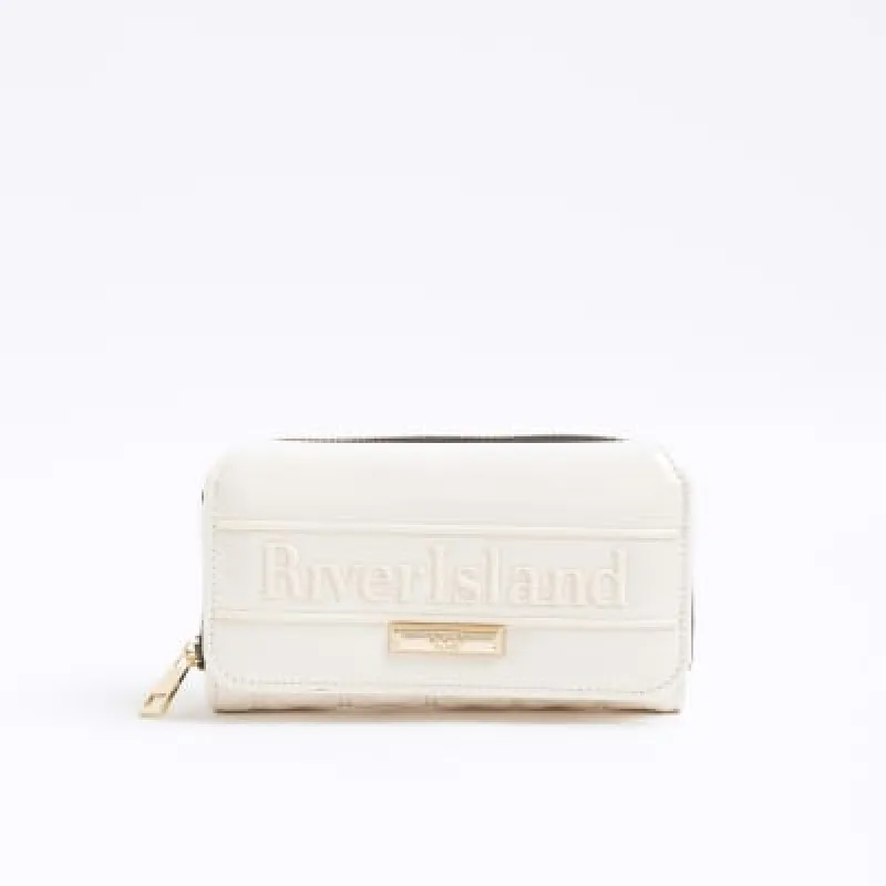 Cream Embossed Flap Zip Around Purse sold by River Island