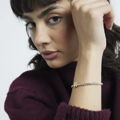 Gold Initial R Bracelet sold by River Island