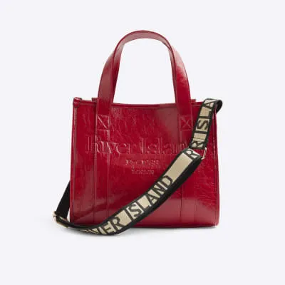 Red embossed tote bag sold by River Island